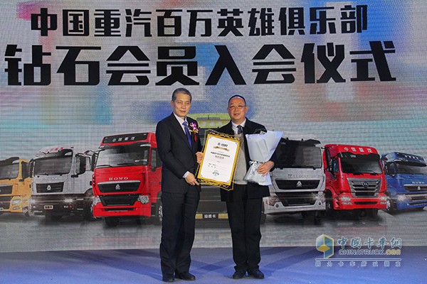 中國重汽濟(jì)南商用車有限公司執(zhí)行總經(jīng)理陳虎(左)為付忠艷頒發(fā)百萬英雄俱樂部鉆石會員獎(jiǎng)牌